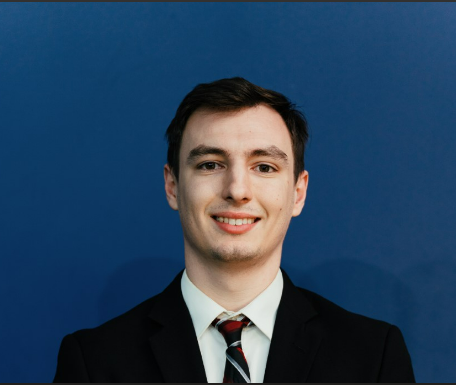 Young man in dark suit smiling