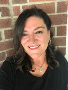 Smiling woman with brick wall background