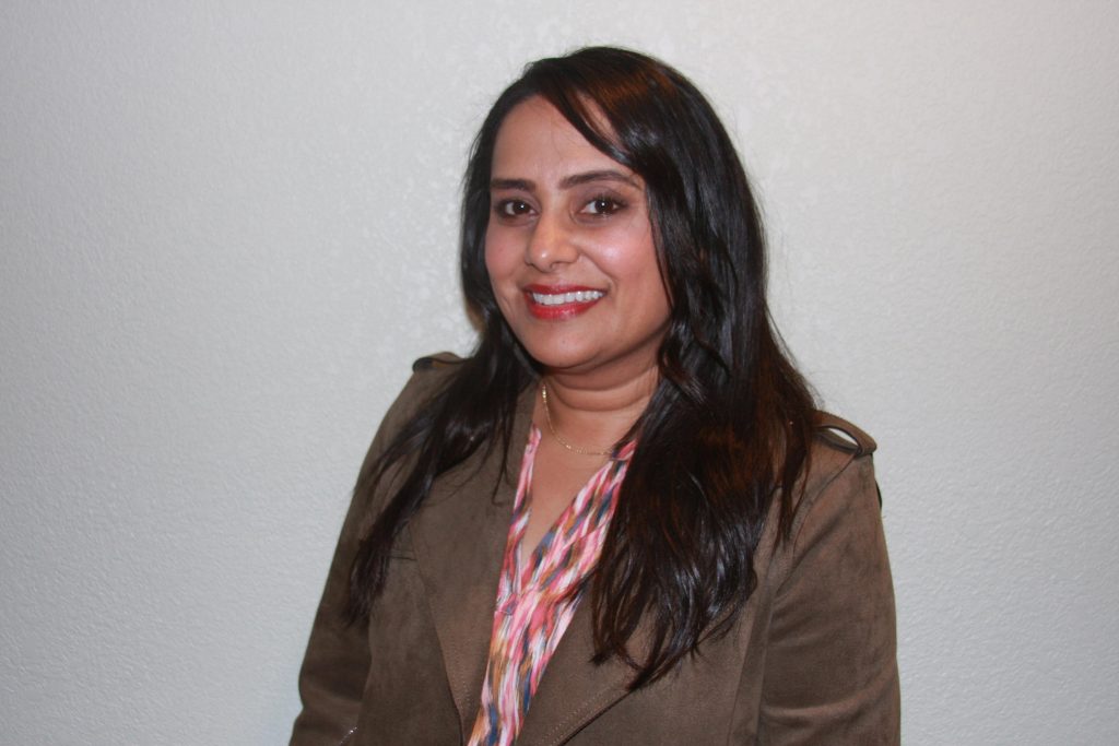 Woman smiling in brown jacket