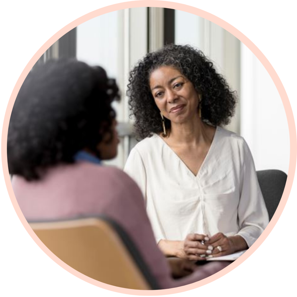 Two people having a conversation in office setting.