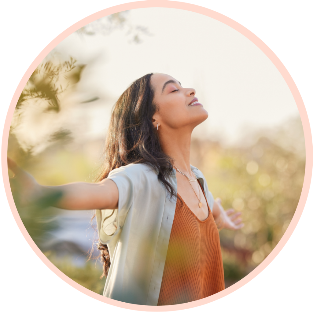 Woman enjoying nature with open arms