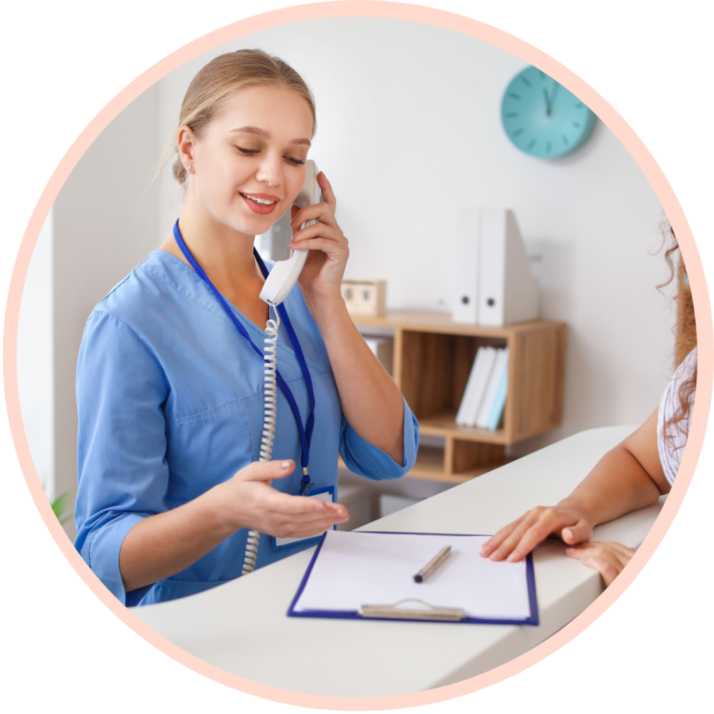 Receptionist answering phone, assisting with paperwork.