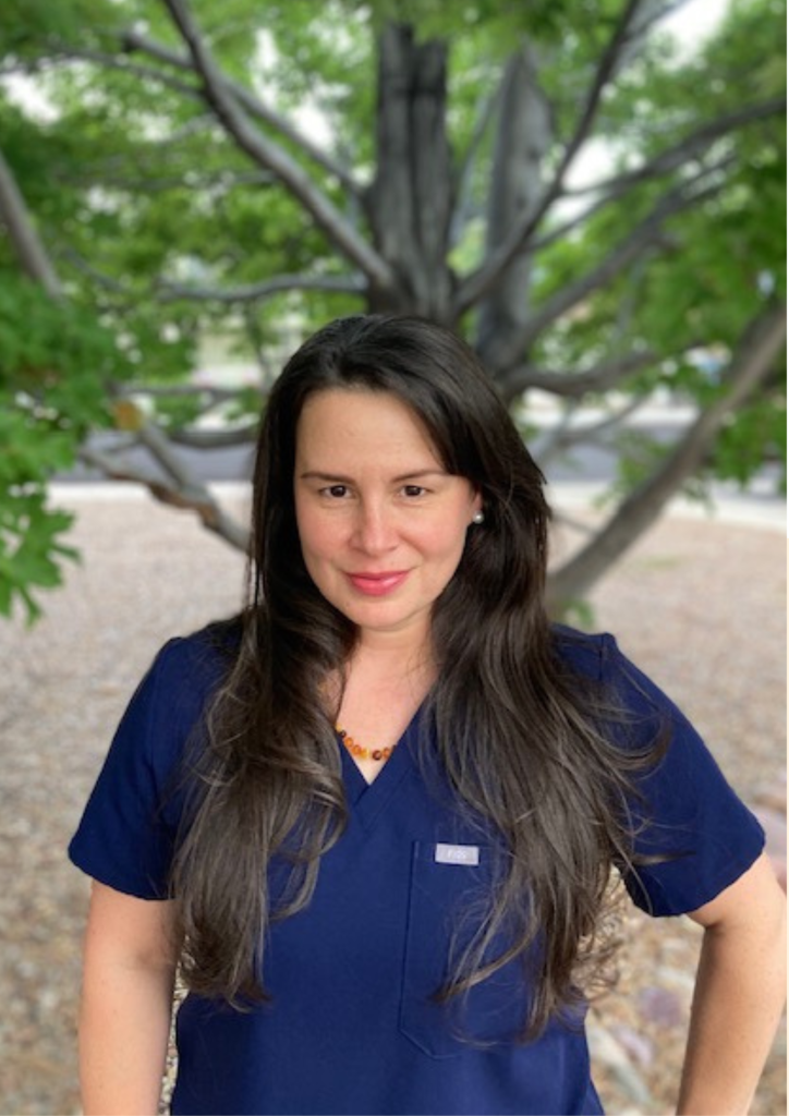 Woman in blue scrubs outdoors