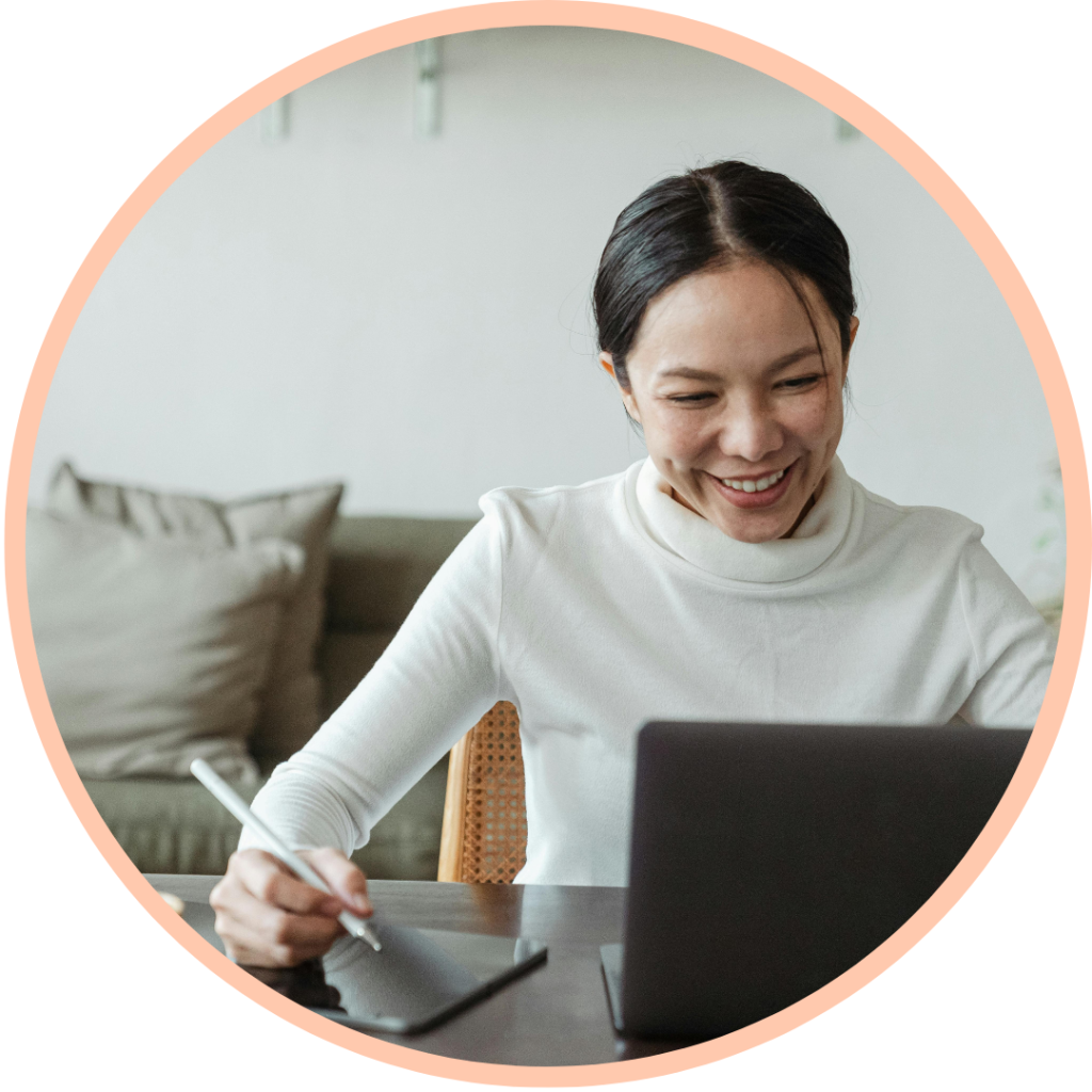 Woman smiling while working on laptop