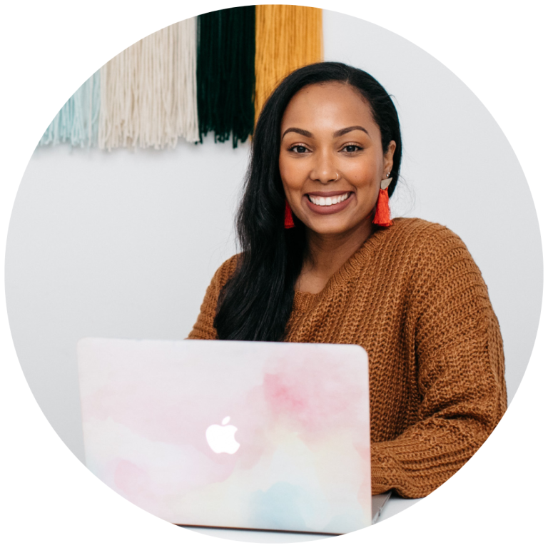 Woman smiling with laptop at desk