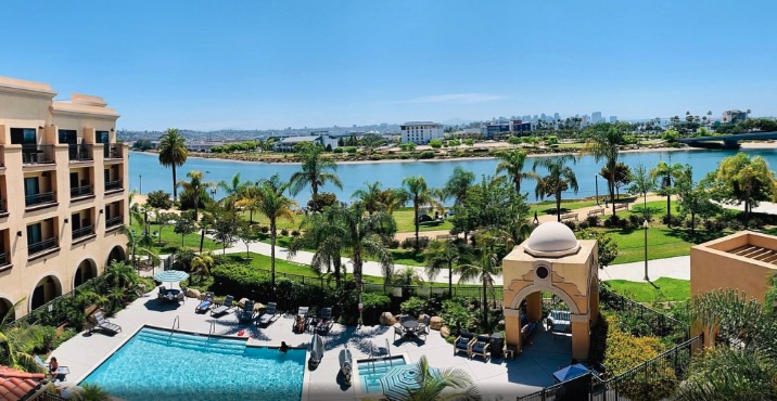 Hotel pool and garden with lake view.